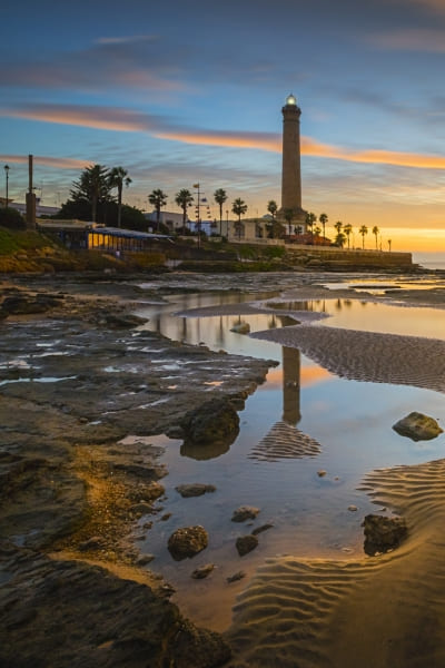 Fotografia de uma praia da Costa do Marfim, onde aparece um farol. A Santy ajuda você com vistos para a Costa do Marfim.